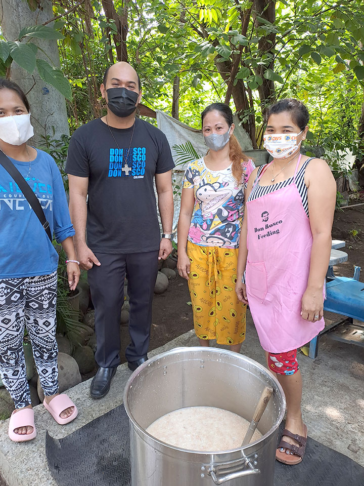 Fr.-Jeffrey-Mangubat-SDB-with-volunteers-for-DB-Feeding-Program-(DB-Feeding-program,-Calauan-(FIN)).jpg